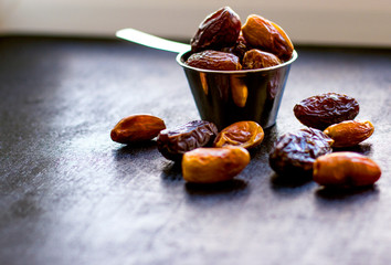  sweet dates in a scoop on the table