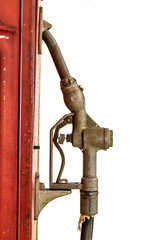 The retro analog petrol pump with nozzle. A vintage red gas oil pump isolated in white background.