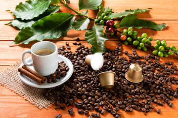 White cup of hot coffee on wooden table. Orange wood pinus.