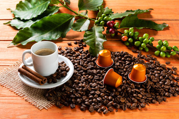 White cup of hot coffee on wooden table. Orange wood pinus.
