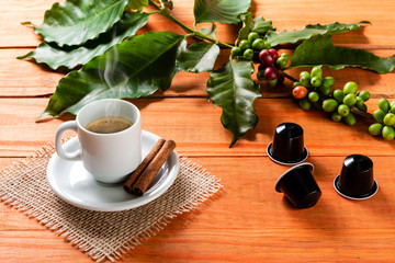 White cup of hot coffee on wooden table. Orange wood pinus.