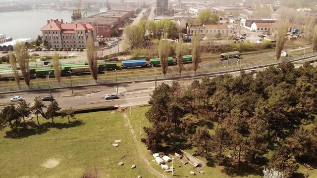 Aerial drone movement with panoramic down up movement startinf from the Roman edifice with Mosaique from Constanta, Romania, anciently known as Tomis and ending over the shipyard