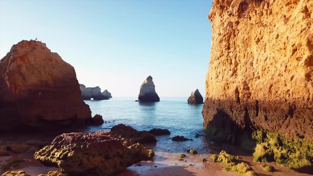 Aerial drone 4k footage of Alvor cliffs at sunrise.Algarve (Portugal)