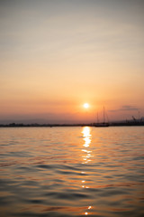 Obraz premium Sunset over harbor with boat