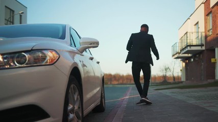 Happy african american man walk dance near white car open door happy sunset young vehicle sit arm auto street automobile businessman buy jacket portrait close up slow motion
