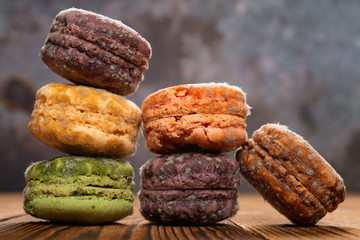 6 pcs moldy macaroons on a wood table close up