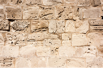 Old, brown, sandy, wall of a stone house in the open air.Close-up.