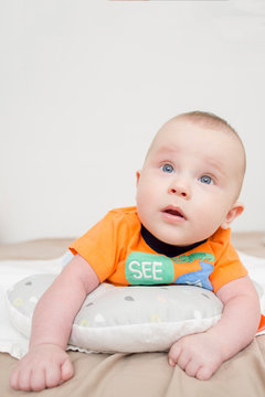 The tummy time of infant. The baby is lying on his stomach. An infant boy is during tummy time.