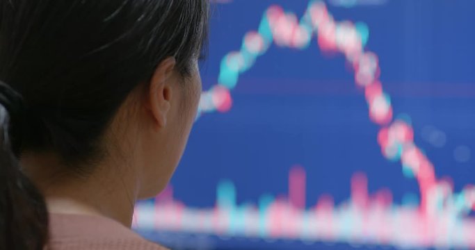 Woman watching the stock market graph