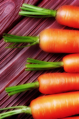 Close up of carrots on rustic wooden background