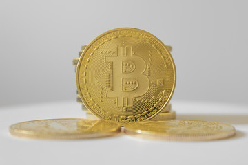 Golden bitcoin on white table and background - business concept of crypto currency.