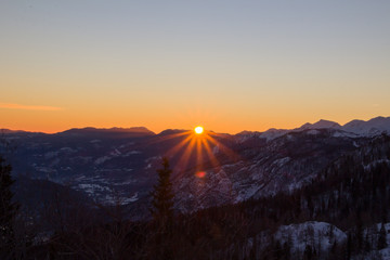 Sunrise high in the mountains, fabulous scenery. Sun rays Shine from behind the mountains. Slovenia, Triglav national park, Julian Alps