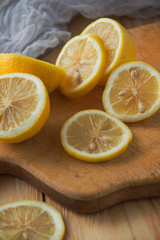 Fototapeta na wymiar Sliced lemon on a wooden plate.Fresh juicy sliced lemon.Rustic morning