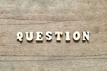 Letter block in word question on wood background