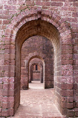 Red old brick tunnel door background