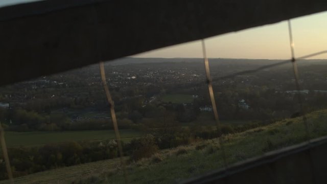 An ESTABLISHING SHOT at sunset with a fence stile in the beautiful countryside.