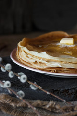 Homemade thin crepes, pancakes on wooden rustic background