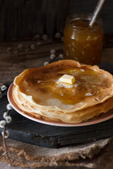Homemade thin crepes, pancakes on wooden rustic background