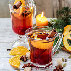 Hot, aromatic christmas drink with spices and orange peel.