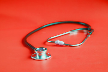 Stethoscope on color background.