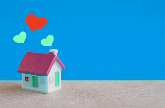 miniature house with heart sign ,love family concept.