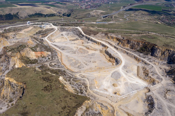 Aerial drone view of a limestone quarry, open pit mine