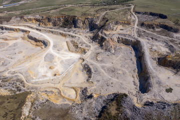 Aerial drone view of a limestone quarry, open pit mine