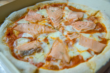Salmon pizza-Italian food style, focus selective