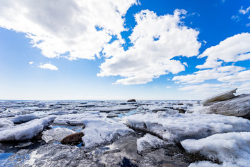 Saint-Petersburg. Shore of the Gulf of Finland in spring. Ice floes , sun and blue water of the Baltic sea.