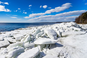 Saint-Petersburg. Shore of the Gulf of Finland in spring. Ice floes , sun and blue water of the...