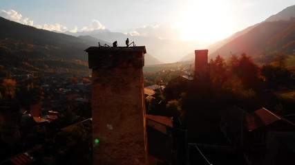 Svan tower in rural town of Mestia Georgia, silhouetted against setting sun