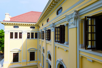 the beautiful yellow building ,Vintage building and many black window . 