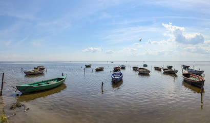 Fototapeta na wymiar Fishing boats, standing on the pier in lake Ladoga. Sunny summer day.