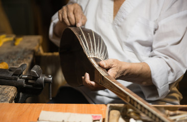 adult master restores old musical instruments. production of stringed instruments