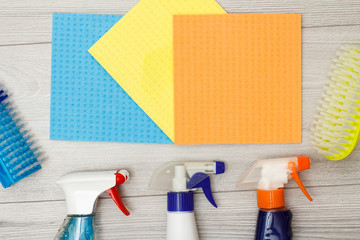 Bottles of detergent, color microfiber napkins and synthetic brushes for cleaning