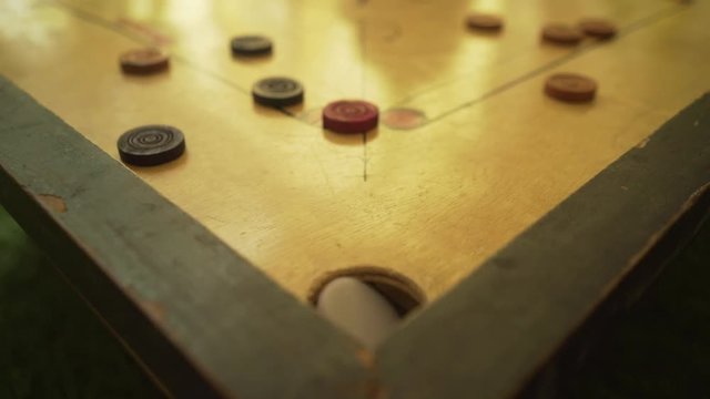 a game of carom with pieces, trying to score ,Carrom board game, slow motion 