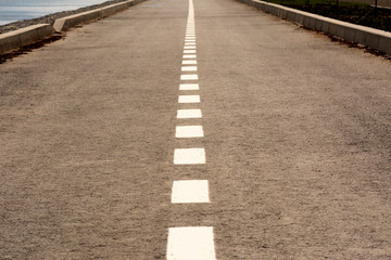 highway with a dividing strip goes into the distance