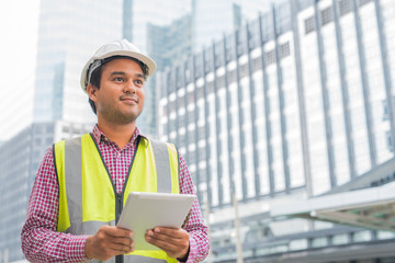 Young civil engineer and construction building background.