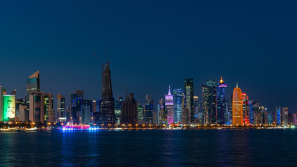 Doha Qatar skyline cityscape with skyscrapers at night