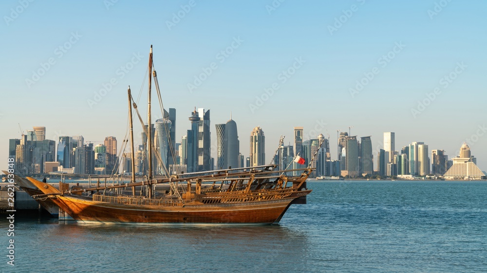 Wall mural Doha Qatar skyline with traditional Qatari Dhow boats in the harbor