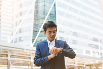 Handsome businessman looking on his watch.