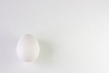 White chicken egg on a white background. Top view. 