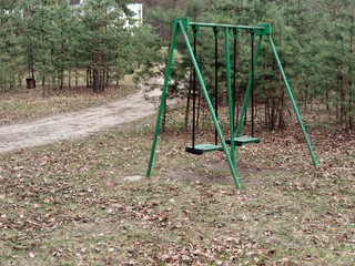 Fototapeta premium children's swing in the recreation area in the forest