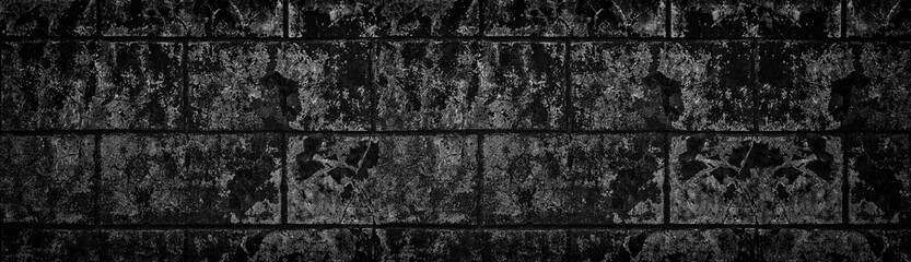 Wide black shabby concrete wall texture. Dark old cracked cement surface panorama. Grunge panoramic background