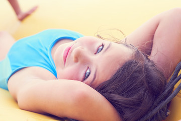 Obraz premium Cute little girl relaxing lying on inflatable mattress close-up portrait.