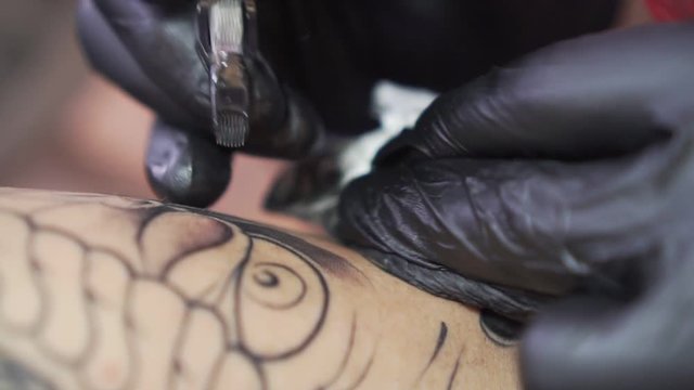 The process of tattooing close-up, slow motion.