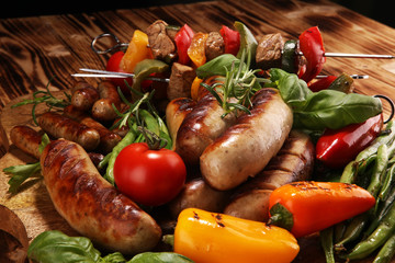 Assorted delicious grilled meat with vegetable on a barbecue. Grilled pork shish or kebab on skewers with vegetables . Food background shashlik