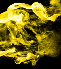 Fototapeta premium Yellow smoke on black background