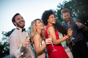 Group of happy people or friends having fun at party
