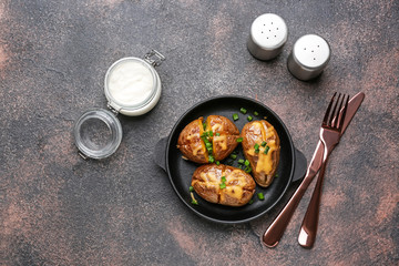 Tasty baked potato on grey background